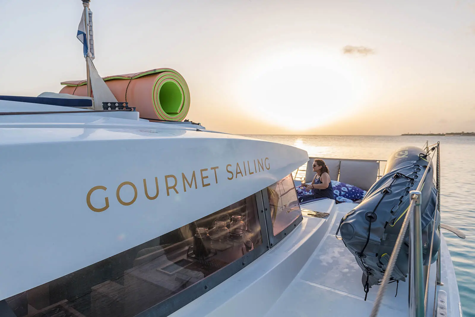 Lagoon 450S power catamaran 'Galaxy' equipped with paddle boards, kayak, floating mat, and snorkeling gear in turquoise waters