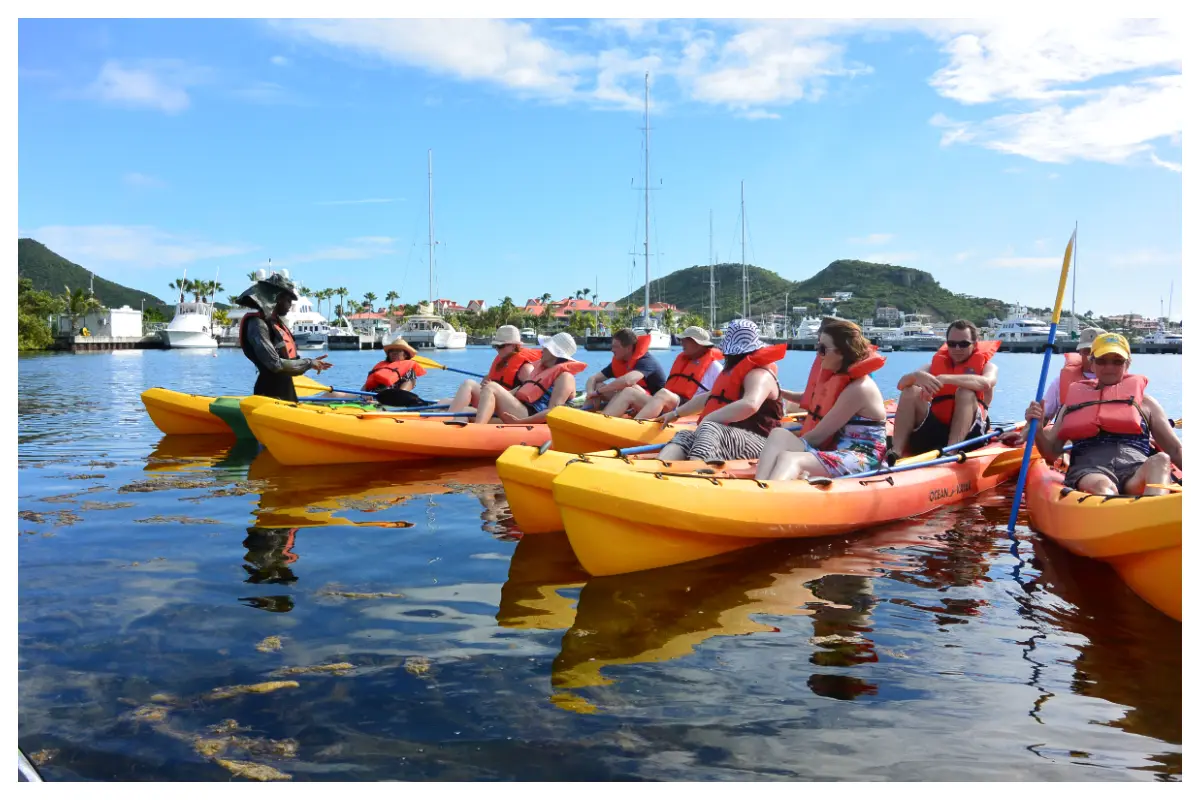 Kayaking through Simpson Bay Lagoon near mega yachts with Tri-Sport SXM.