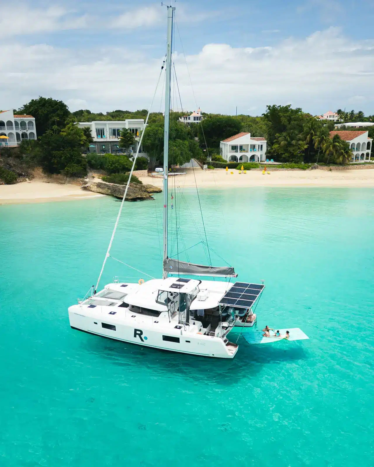 Renegades catamaran sailing near St. Maarten turquoise shore