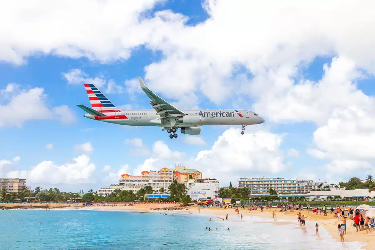 Princess Juliana International Airport, flying just above Maho Beach in Sint Maarten, offering a thrilling aviation spectacle We Accept a Discount Card - Discounts Sint Maarten, Saint Martin, SXM - Coupon Book - % Guide - Partners S